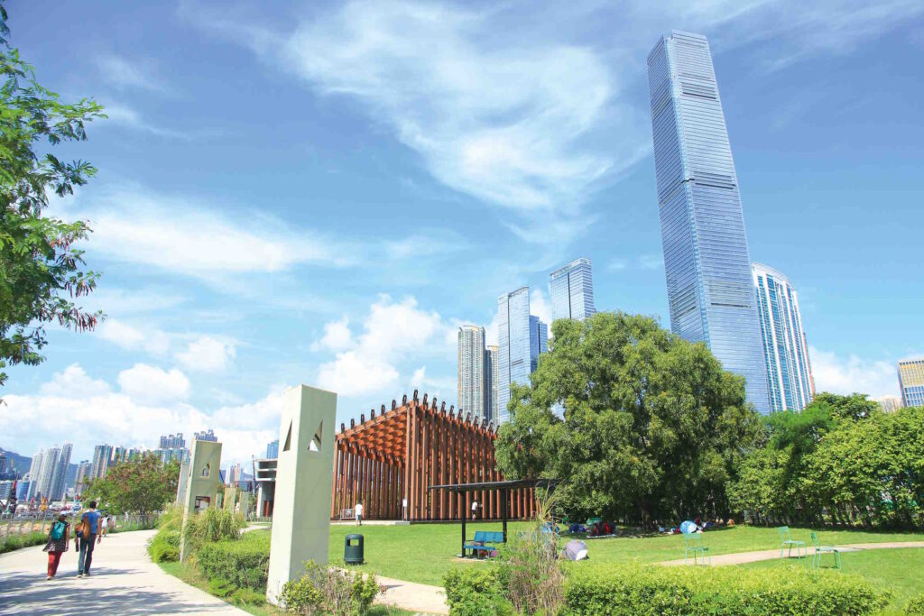 View along the park on the waterfront of the West Kowloon Cultural District, looking towards the M+ and the towering ICC building.