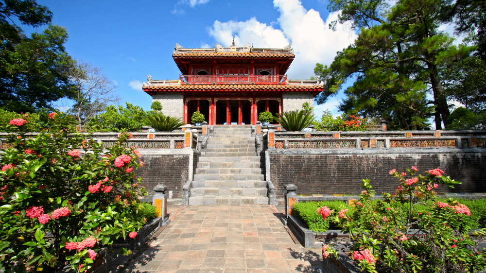 A red tomb fronted by a rose garden near Hue, Vietnam.