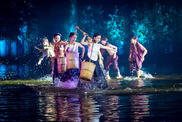 Performers dance in water on stages at the Quintessence of Tonkin show, Vietnam.