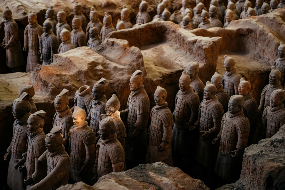 A close-up view of the Terracotta Warriors, an ancient army of life-sized clay soldiers standing in excavated pits, part of the burial complex of China's first emperor, Qin Shi Huang.