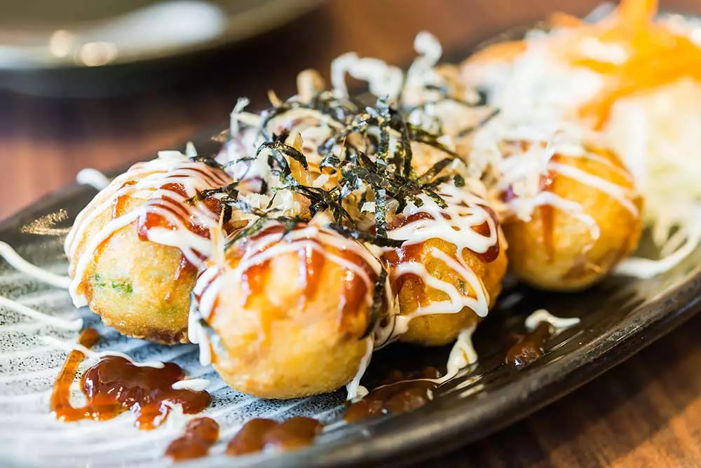 Which city is the famous Dontonburi food district found?