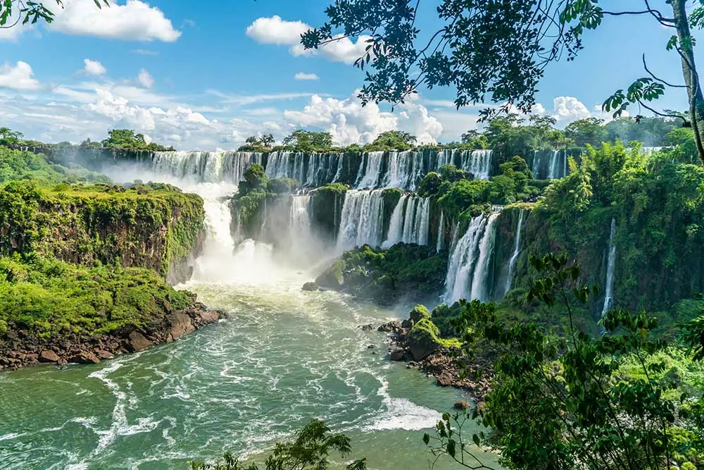 What two countries does Iguazu Falls spread over?